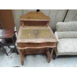 A 19th century golden oak desk in the Davenport style having raised ledge back, with later skiver