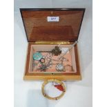 A small wooden jewellery box containing a selection of white metal and other jewellery including