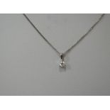 A diamond pendant, approx 0.125ct in a claw set mount on a white metal chain stamped 18K