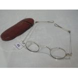 A cased pair of Georgian Britannia standard silver wig spectacles of traditional form, London
