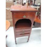 A late Victorian mahogany music cabinet having recess and drawers, on tapered support