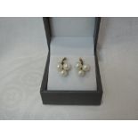 A pair of 9ct gold and cultured triple pearl stud earrings