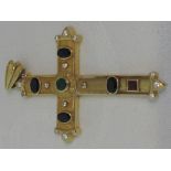 A yellow metal gem set cross having sapphire, ruby and emerald decoration with white paste stones to