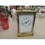 An early 20th century brass carriage clock of traditional French design, having enamel face with
