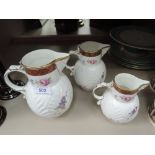 A set of three graduated Coalport jugs in the Copy Caughly Mask Head design