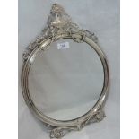 An Edwardian silver mirror of circular form having urn and swag applique decoration, London 1909,
