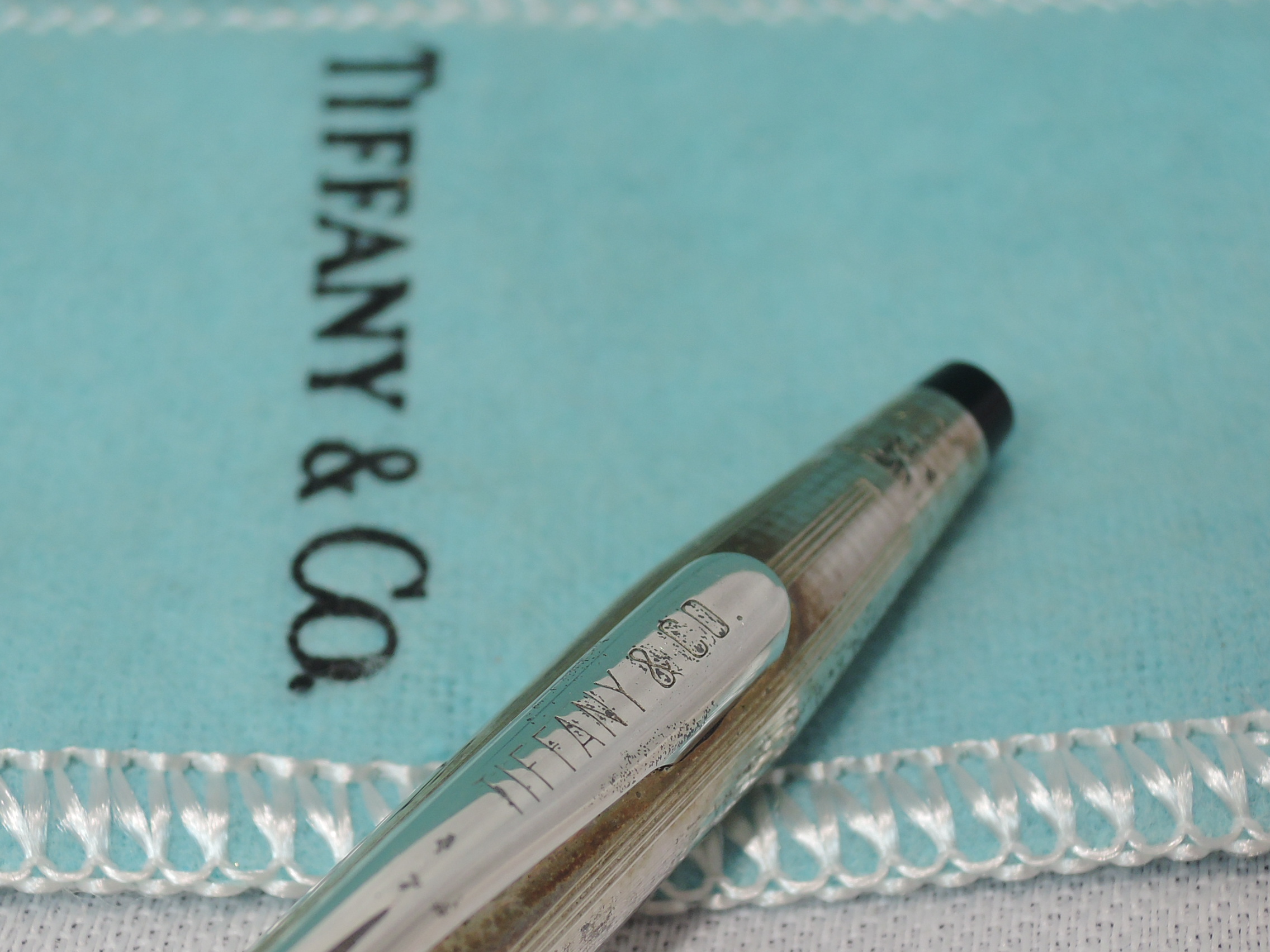 A Tiffany & Co silver ball point pen having striped decoration and stamped Cross sterling silver, - Image 2 of 2