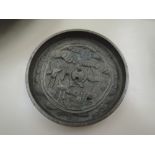 A Chinese brass dish having extensive cast pictorial decoration