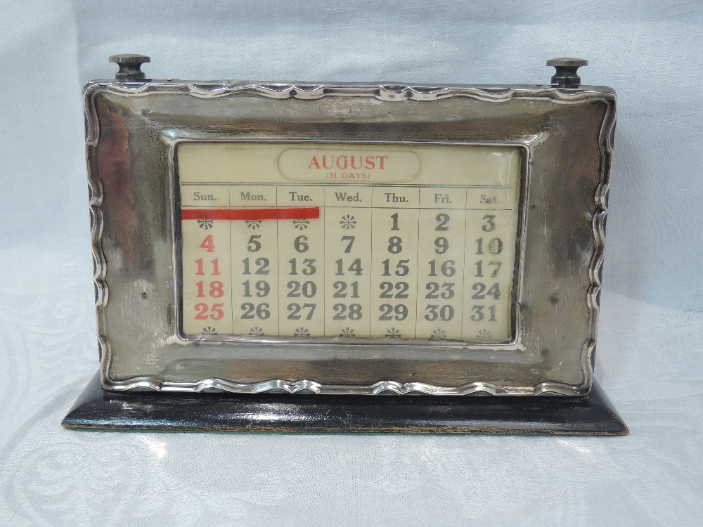 A silver fronted perpetual desk calendar having moulded decoration to rim, Birmingham 1924, makers