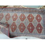 A mid/late 20th century rug in the Tukeman style having russet and blue ground, 80 x 134cm