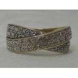 A lady's dress ring having a twist band set with diamond chips on a 9ct gold loop, size M