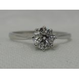 A lady's diamond solitaire dress ring, approx 0.50ct in a claw set mount on a white metal loop