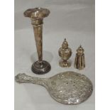 Four pieces of HM silver including two pepperettes, a hand mirror and stem vase