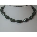 A polished carved green slate bead necklace, approx 24'