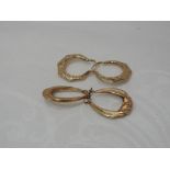 Two pairs of 9ct gold hoop earrings having moulded decoration