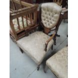 A late Victorian/Edwardian rosewood armchair having foliate and line inlay decoration with later