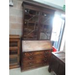 An early 19th century mahogany full height bureau bookcase having astral glaze top over fall front