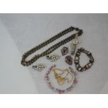 A small selection of vintage and modern costume jewellery including white metal collar clips,