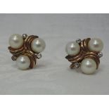 A pair of ciro cultured pearl screw back earrings having a trio of pearls with cubic zirconia in a