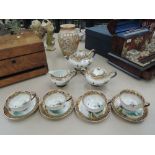 A Noritake style gilt heightened tea service having pictorial lake landscape decoration