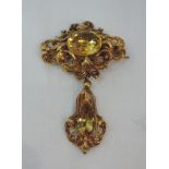 A Victorian yellow metal brooch having central citrine in a moulded mount with removable drop and