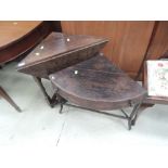 A late Victorian dark oak corner table having carved drop leaf and baluster supports, and a part