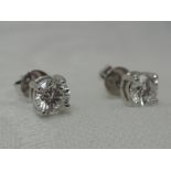 A pair of diamond solitaire stud earrings, each approx 0.50ct in 4 claw 18ct white gold mounts,