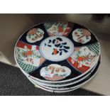 Four Japanese Imari chargers in traditional palette