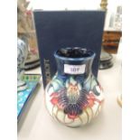 A modern Moorcroft vase of urn shape in Anna Lily pattern, on blue/cream ground, impressed and