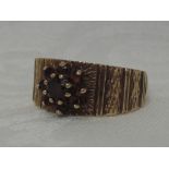 A lady's dress ring having a garnet cluster on a bark effect band effect loop, size O