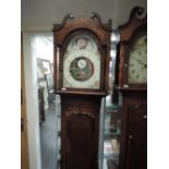 An early 19th century oak longcase clock having swan neck and pillar hood, containing painted dial