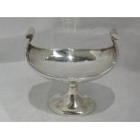 An oval silver comport dish of plain stylised boat form on oval pedestal, Birmingham 1919, Henry