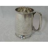 A small silver tankard of plain baluster form having moulded handle and pedestal foot, Chester 1940,