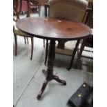 A 19th century pedestal table having circular top on turned column and triple splay legs