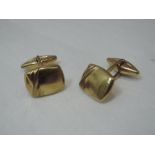 A pair of 9ct gold cufflinks having moulded rectangular panels with open bars to lozenge shaped