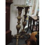 A pair of 19th century gilt wood and gesso torchere stands in the ornate Baroque style having