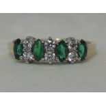 A lady's dress ring having cubic zirconia and green marquise cut stones in a claw set mount on a