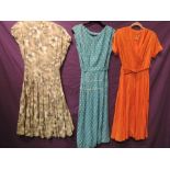 Three vintage 1940s to early 50s dresses,blue polka dot with ric rac detailing to skirt, one pale