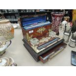 A Victorian birds eye maple stationery rack having raised dome section with brass applique and