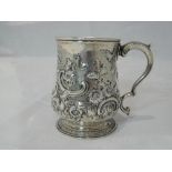 A small silver tankard having floral repousse decoration, plain cartouche and moulded handle, London