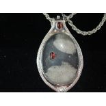 An American silver artisan pendant with rope chain designed by Byron Weege California 2010, having a