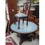 A Victorian style dining table having circular painted top on pedestal supports and a set of four