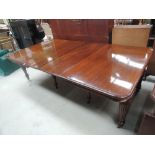 A 19th century mahogany extending dining table having extra leaves and turned and fluted legs