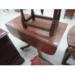 A 19th century mahogany centre/dining table having drop leaf top on bulbous column and reeded