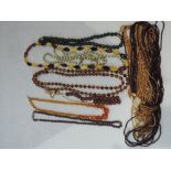 A selection of strings of beads including cut amethyst style, jade style, facetted, glass bead etc