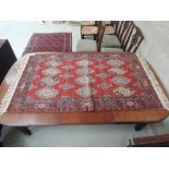A 20th century rug of whirl crewel work design, on burgundy ground, 36in x 58in