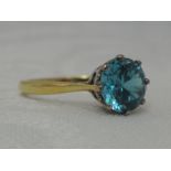 A lady's dress ring having a blue topaz solitaire, approx 2ct in a claw set mount on an 18ct gold