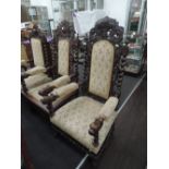 A late Victorian oak Jacobean style armchair having carved crest of armorial design with twist and