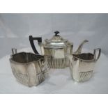 A Victorian silver three piece tea set of canted rectangular form having gadrooned decoration,