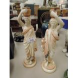 A pair of Royal Worcester figures modelled as water carriers on blush ground on blush ground,